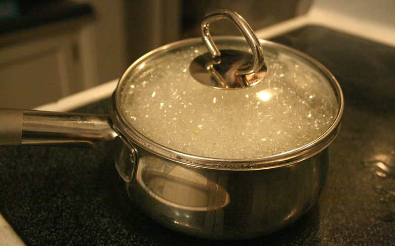 A pot of water at a rolling boil on a gas stove