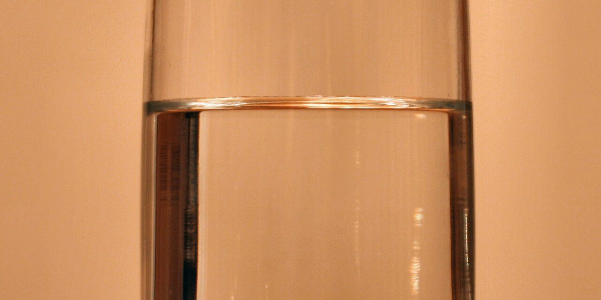 A child drinking a glass of clean, filtered water at home
