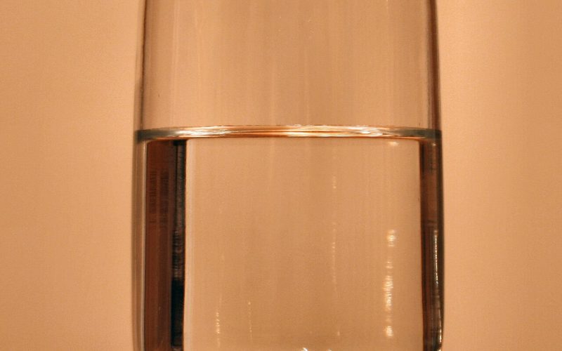 A child drinking a glass of clean, filtered water at home