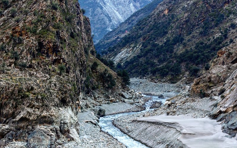 Clear mountain stream flowing over rocks in northern Pakistan